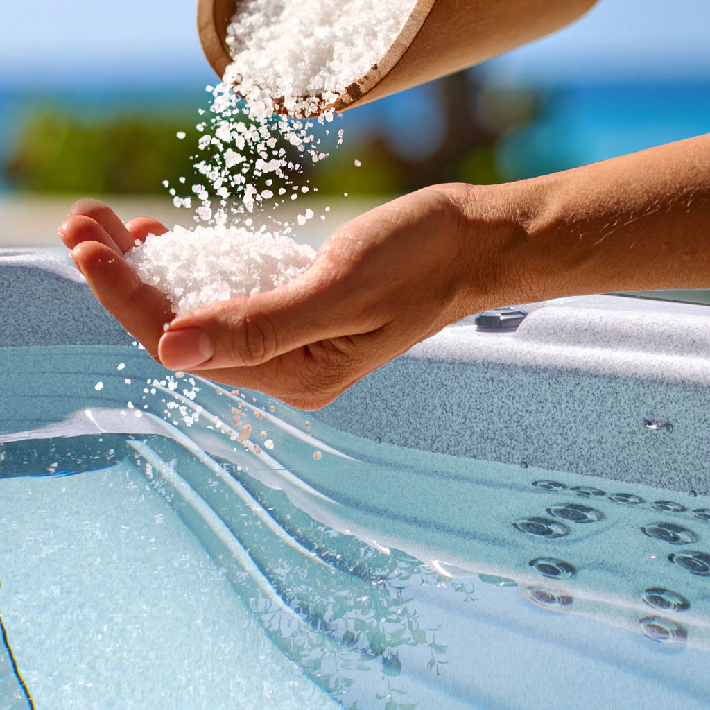Scoop adding salt to a Hot Tub
